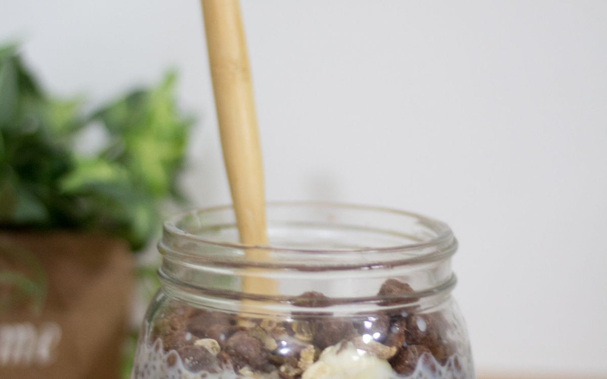 Overnight oats topped with sliced banana in a glass jar