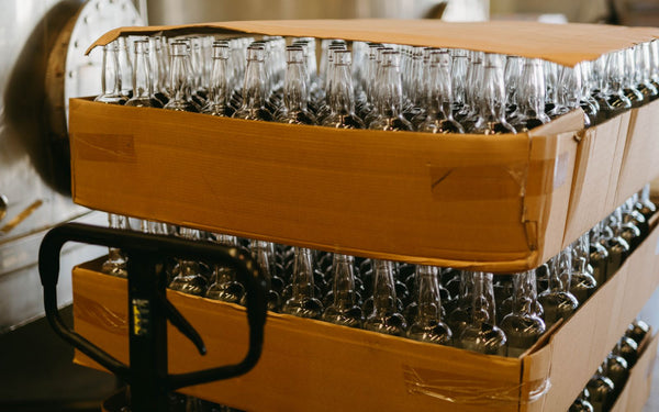 Stacks of empty glass bottles in a factory for production and packaging