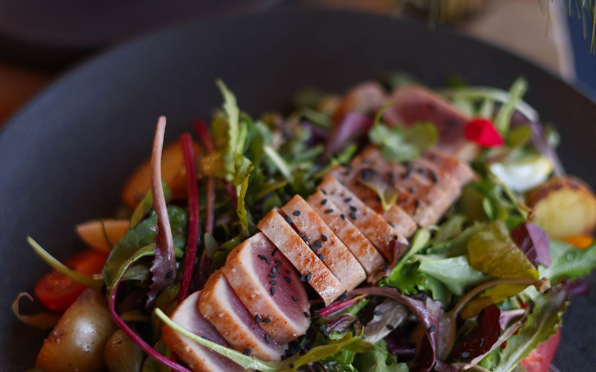 Tuna nicoise salad with eggs, potatoes and dressed greens