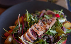Tuna nicoise salad with eggs, potatoes and dressed greens
