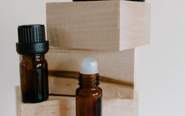 A collection of brown glass bottles of different sizes arranged on wooden blocks