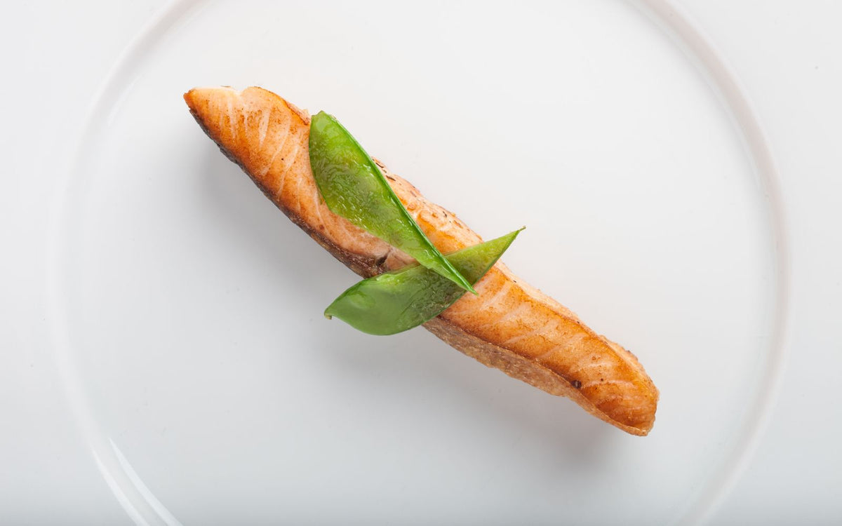 A roasted salmon fillet with herb garnish