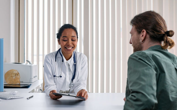 A doctor and patient engaging in a positive consultation in a bright clinic setting