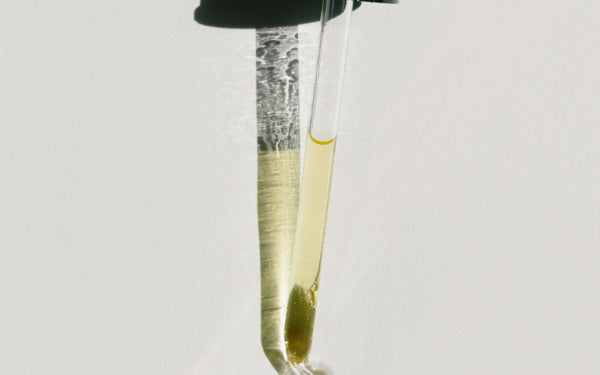 Close-up of a dropper casting a shadow, highlighting minimal design