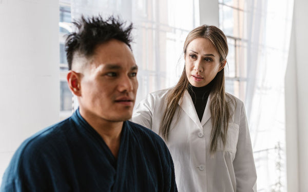 A doctor consults with a patient in a bright indoor clinic setting