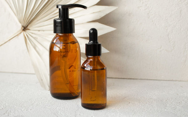 Two amber glass bottles of different strengths, one with a pump and one with a dropper