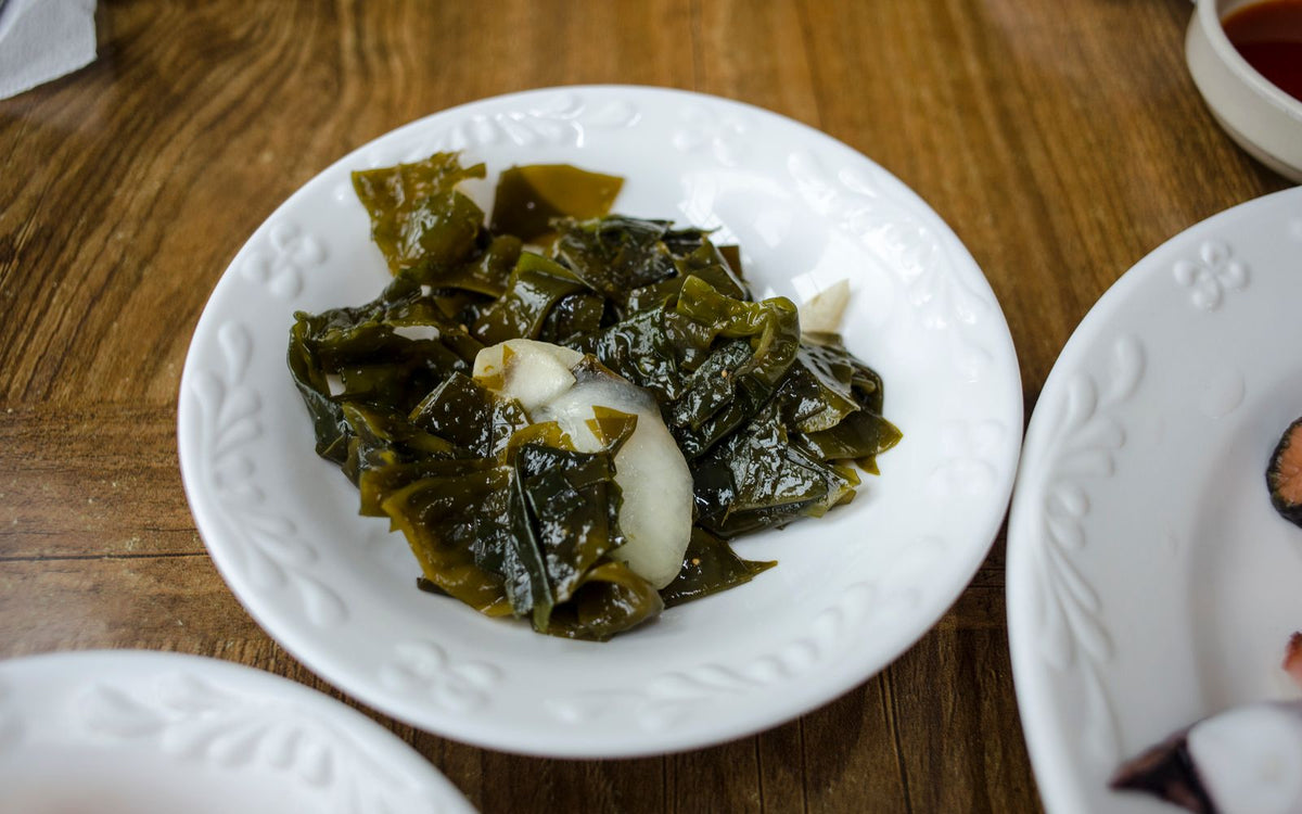 A bowl of seaweed salad with sesame seeds